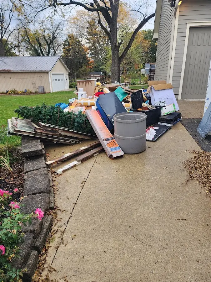 Dumpster being loaded with debris for Residential Dumpster Rental in Chattahoochee Hills